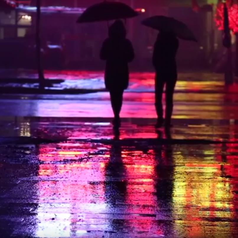 Picture of two persons walking on a street.